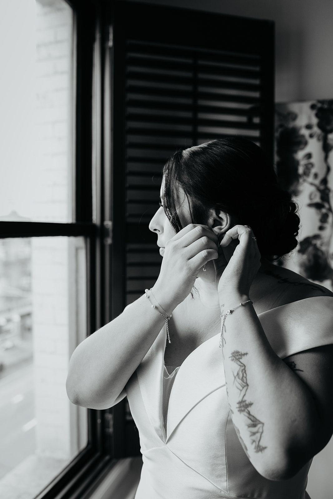 drive putting on her earrings during their Coopers Hall wedding.