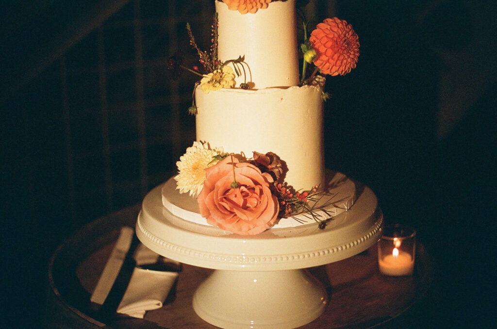 wedding cake sitting on a wine barrel.