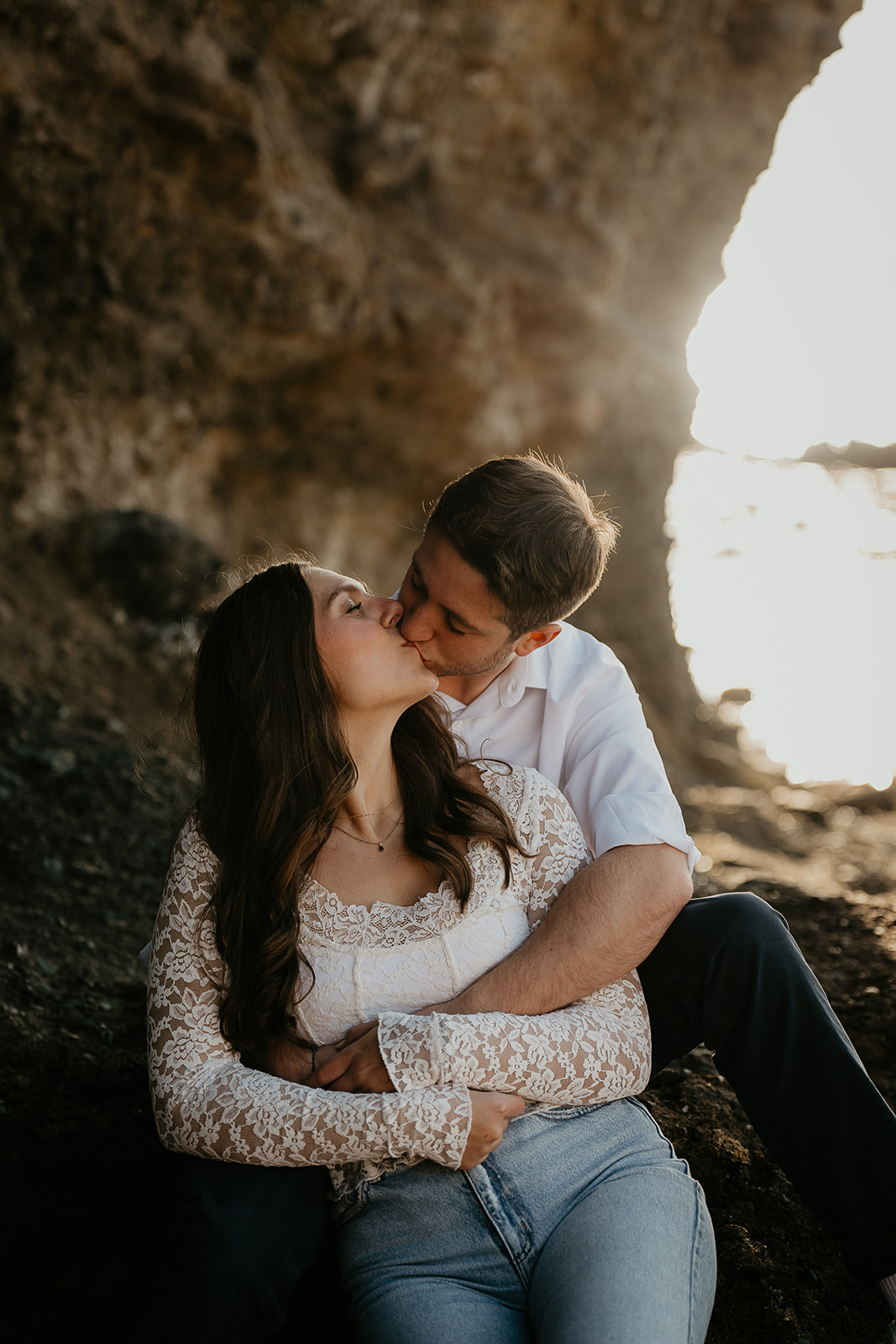 couple kissing in a sea cave.
