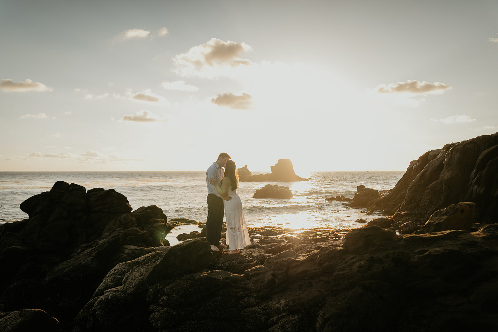 couple kissing during sunset during their Laguna Beach engagement.