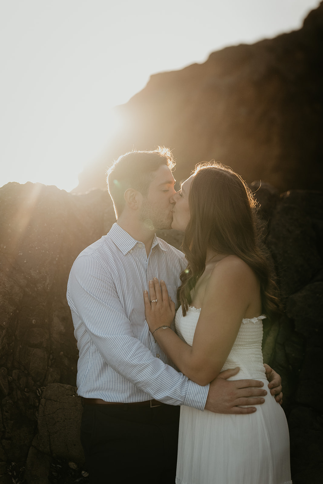 couple kissing at sunset on the beach.