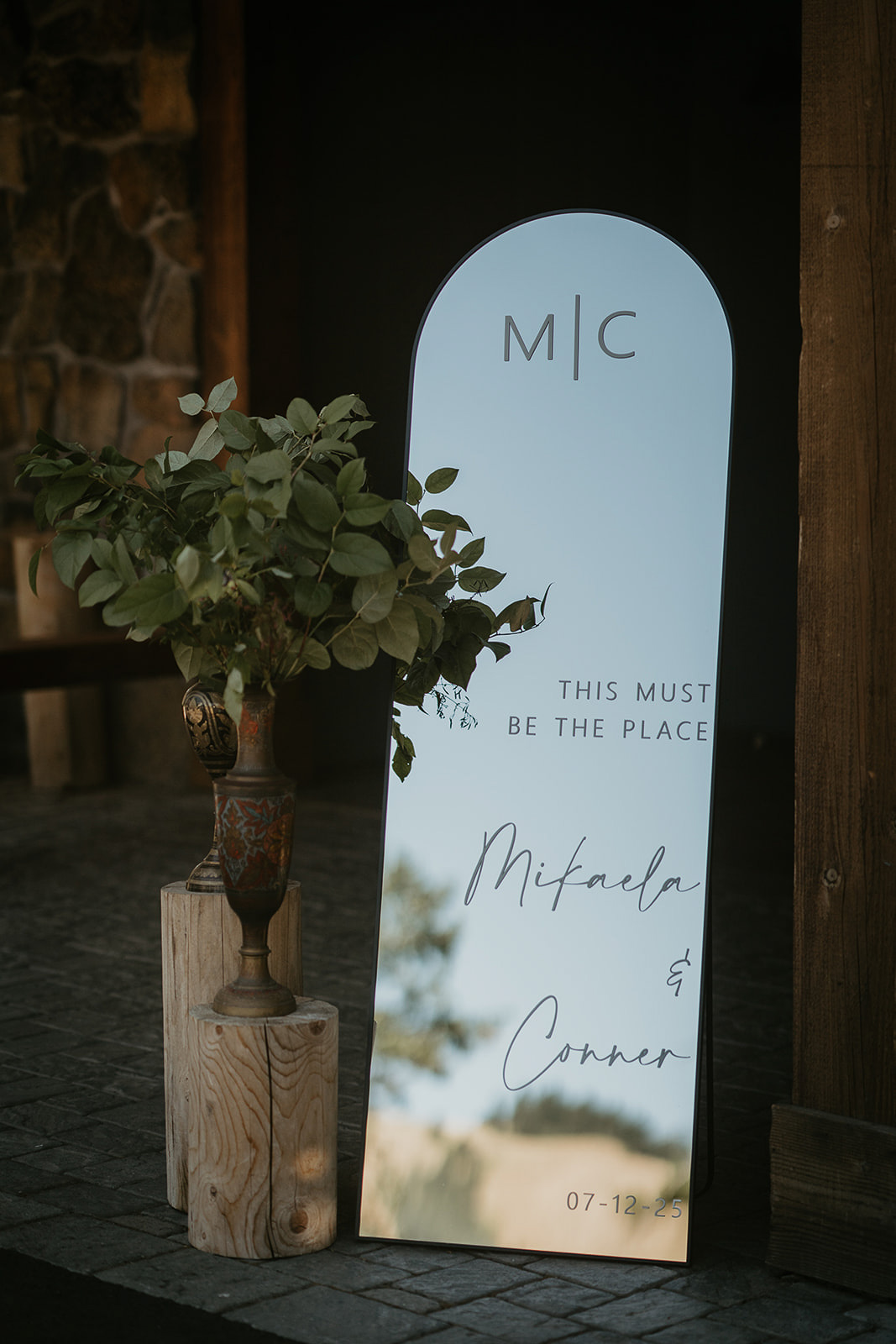 a mirror that reads "This must be the place Mikaela and Conner"