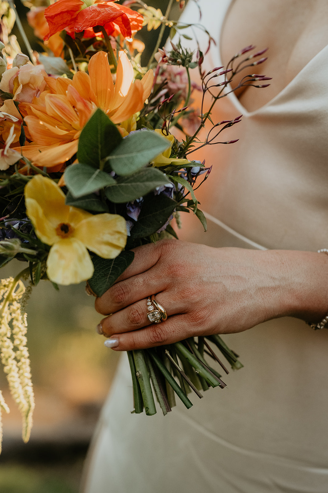 details of the bride's rings and a bouquet of flowers.