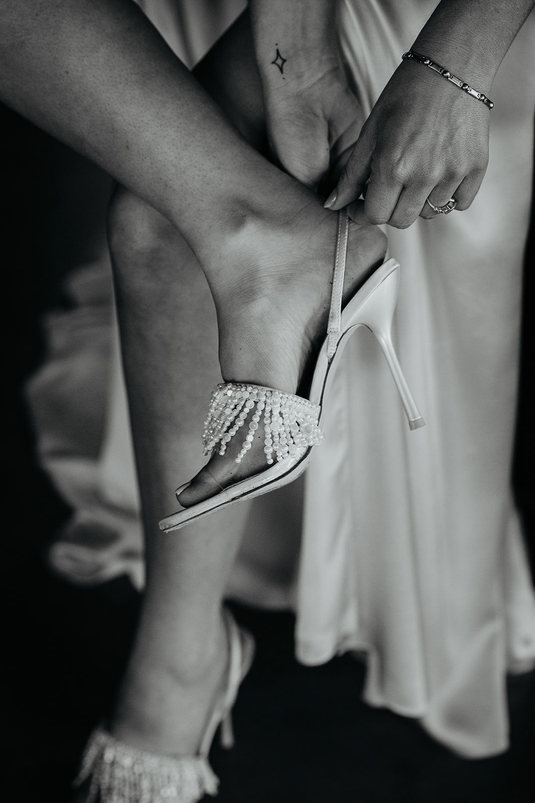 the bride putting on her heels during their vintage inspired wedding.