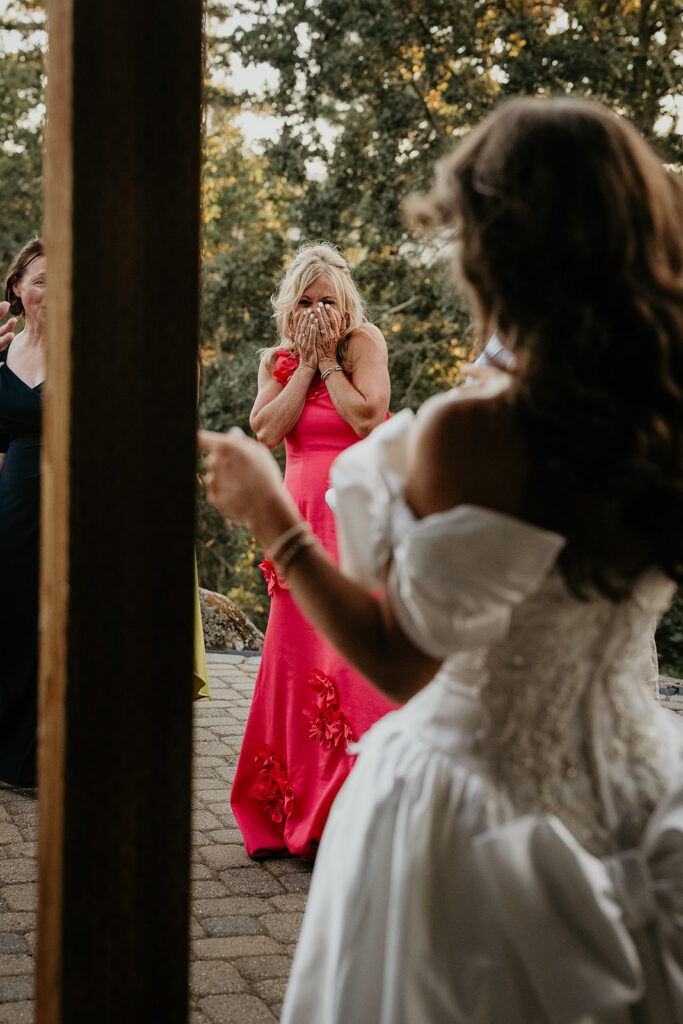 the bride surprising her mom during an outfit change during her vintage inspired wedding.