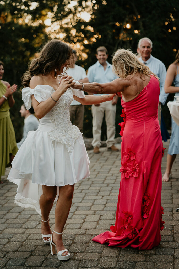the bride and her mom dancing.