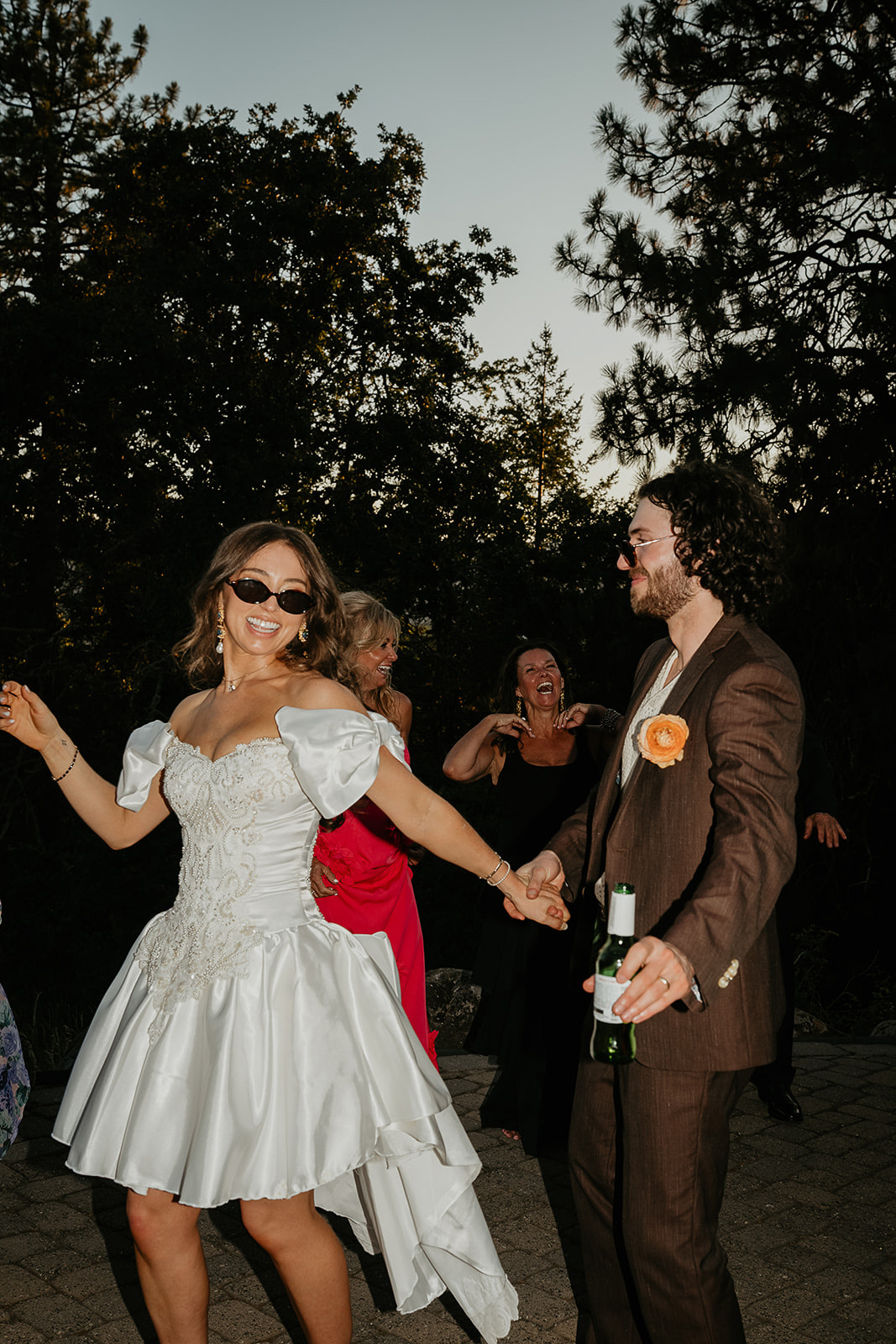 the newlyweds partying and wearing sunglasses during their vintage inspired wedding.
