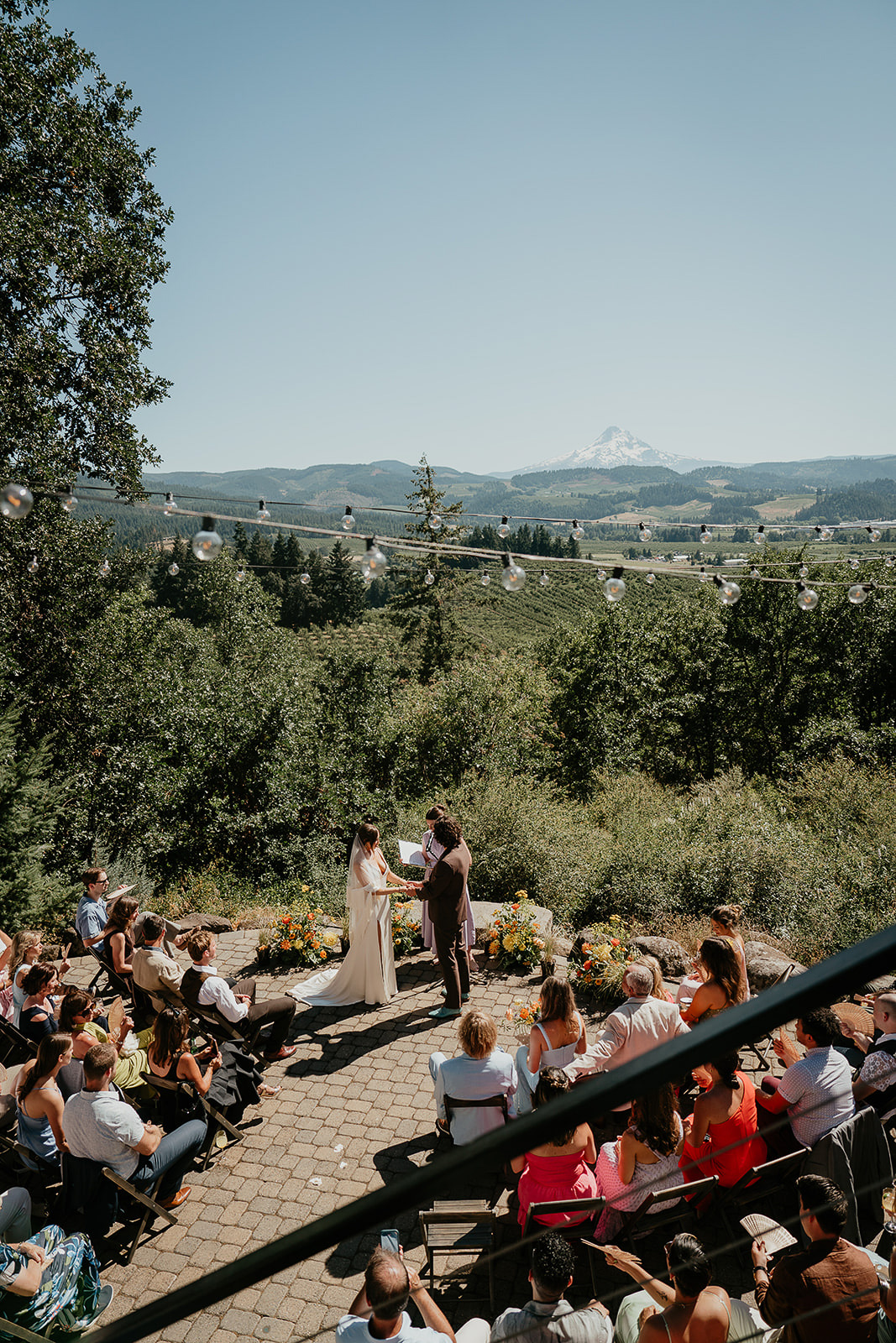 newlyweds holding hands during their wedding ceremony at crag rat hut.