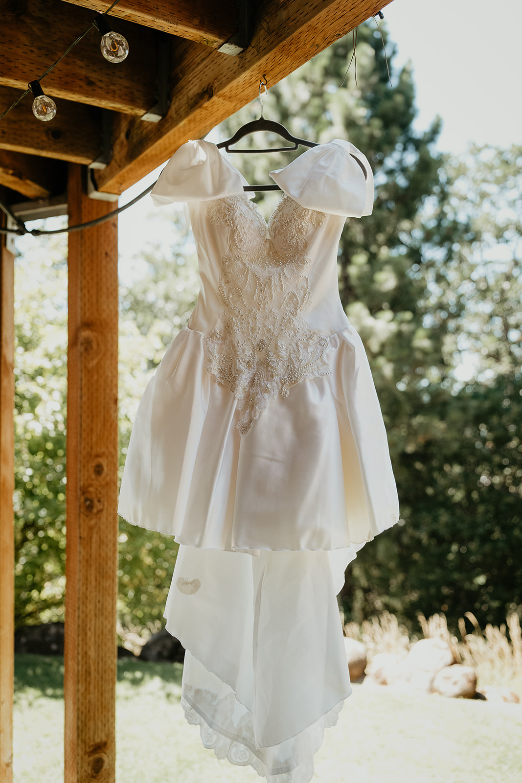 a wedding dress hanging from a pavilion.