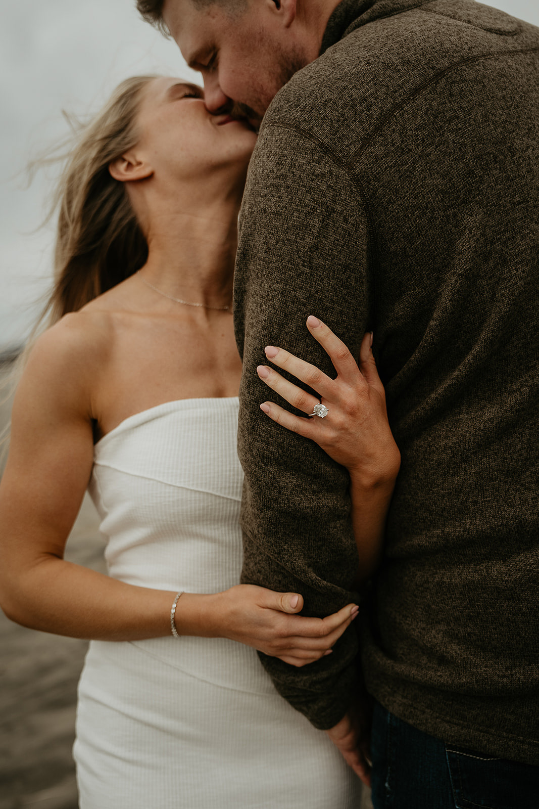 couple kissing after a classic surprise proposal, one of the ways to propose.