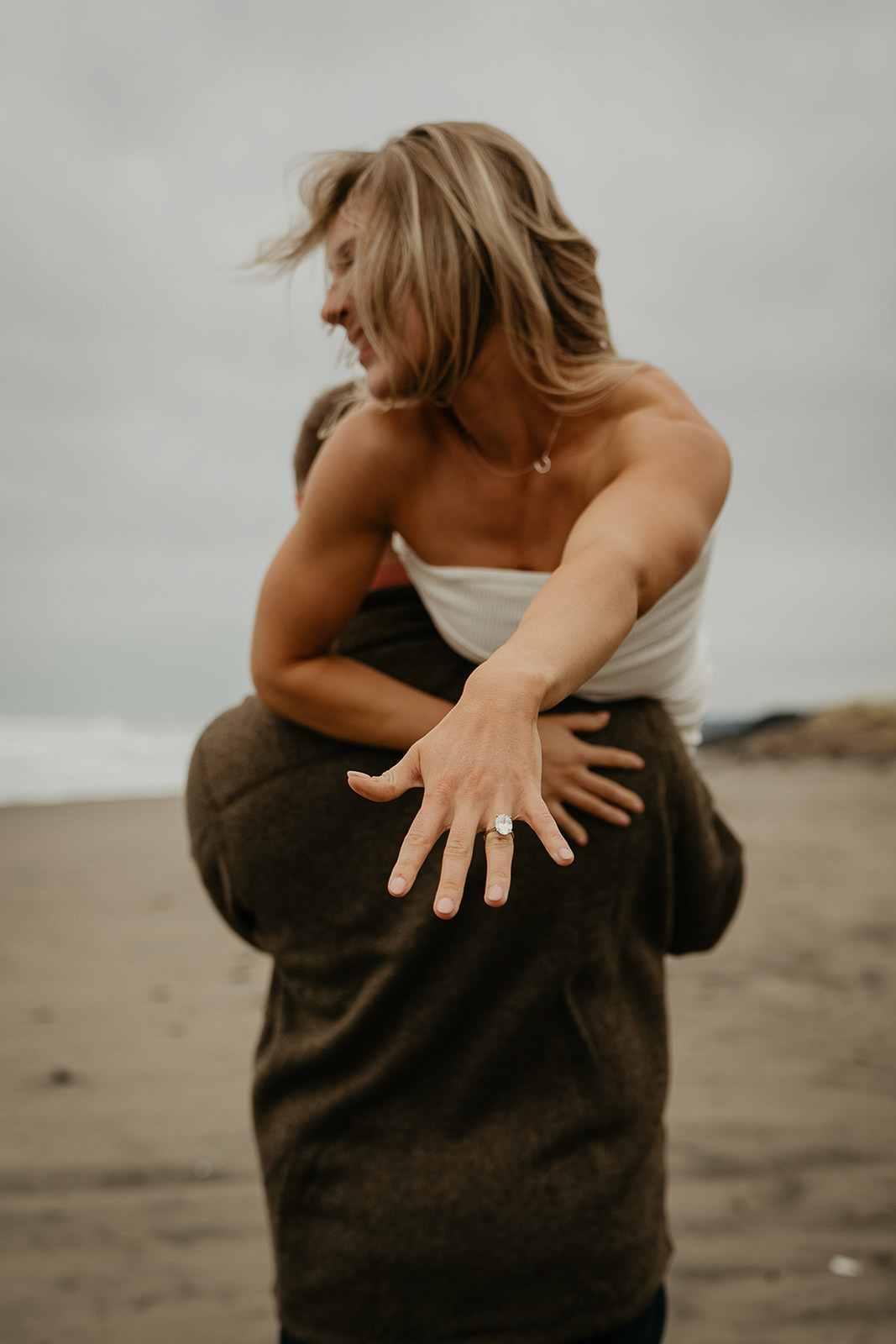bride to be showing off her engagement ring after a classic proposal. one of the ways to propose.