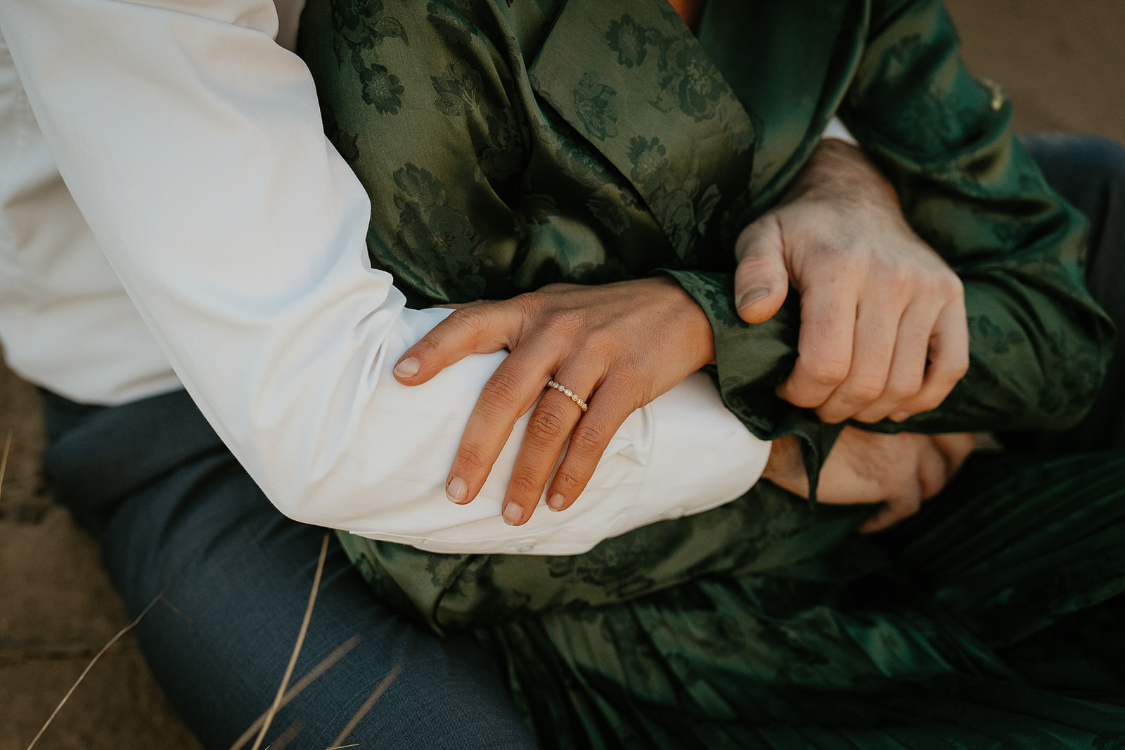 close up of couples hands, specifically highlighting the engagement ring. 