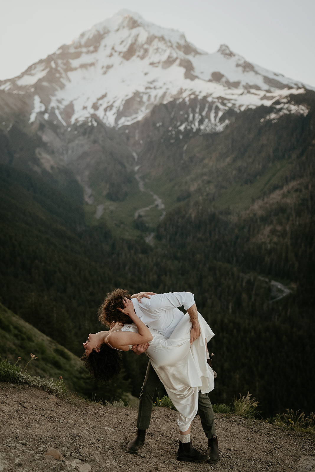 couple dancing in the mountains during their wedding anniversary photoshoot.