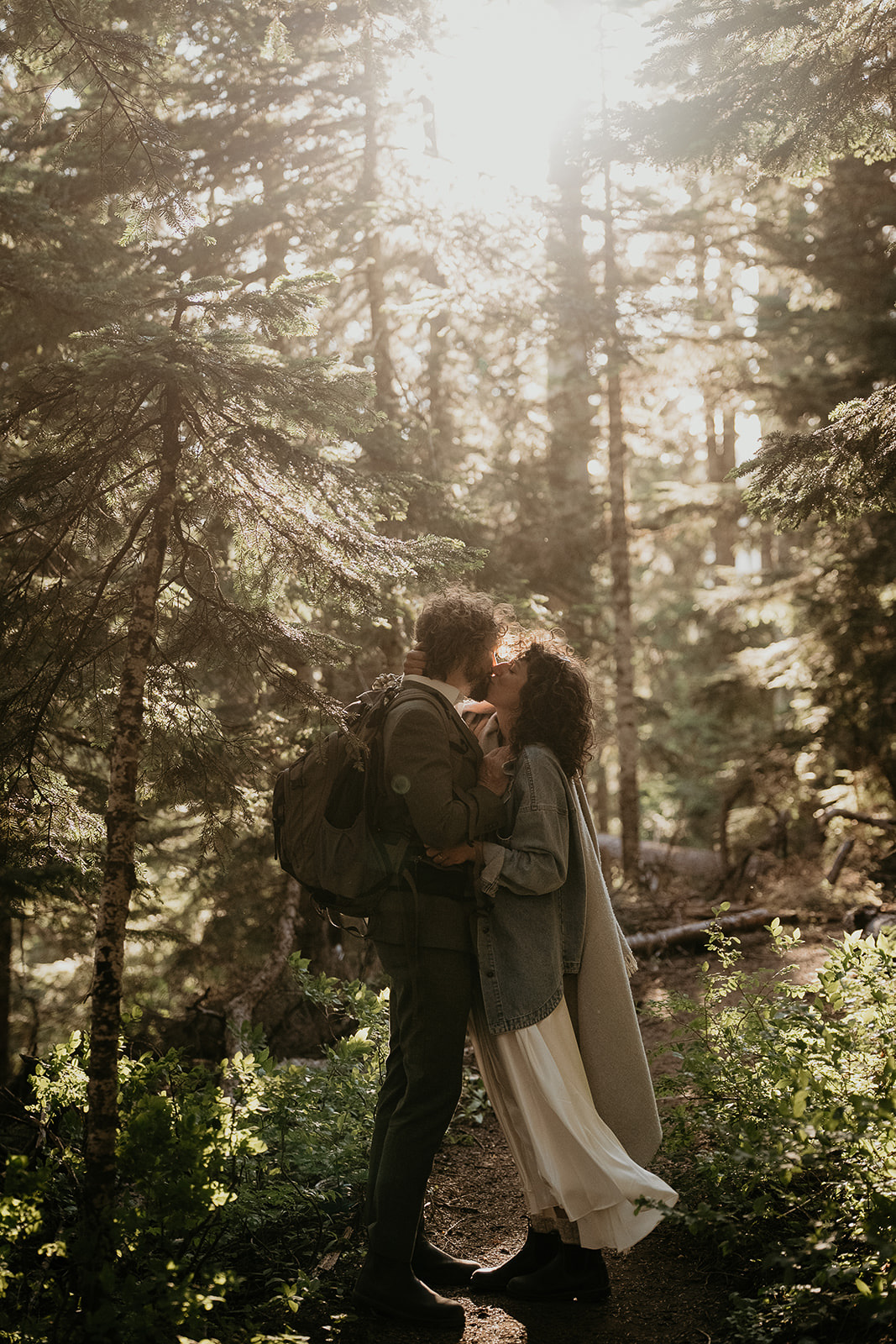 couple kissing in a firest during their wedding anniversary photoshoot.