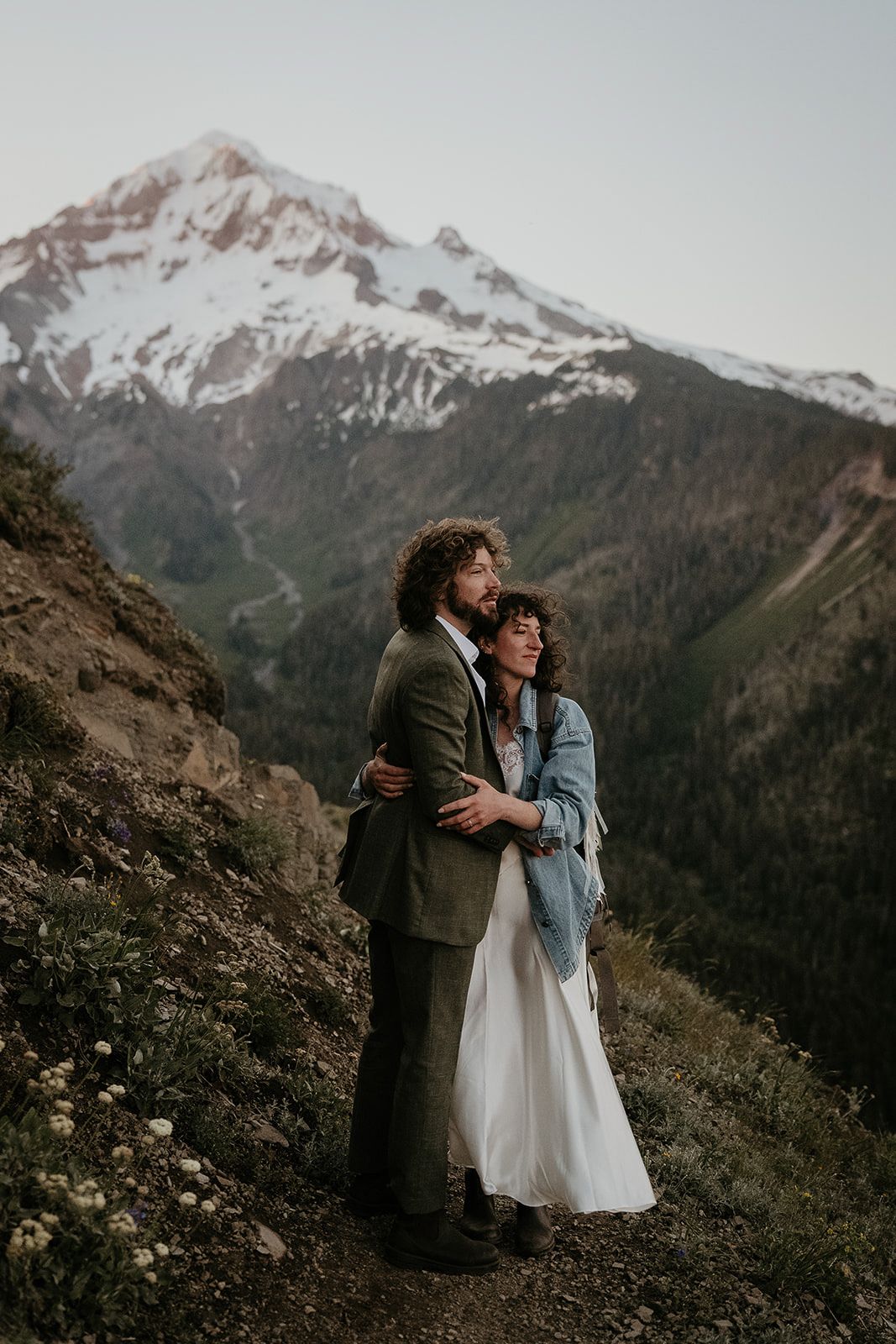 couple hugging with mount Hood in the background during their wedding anniversary photoshoot.