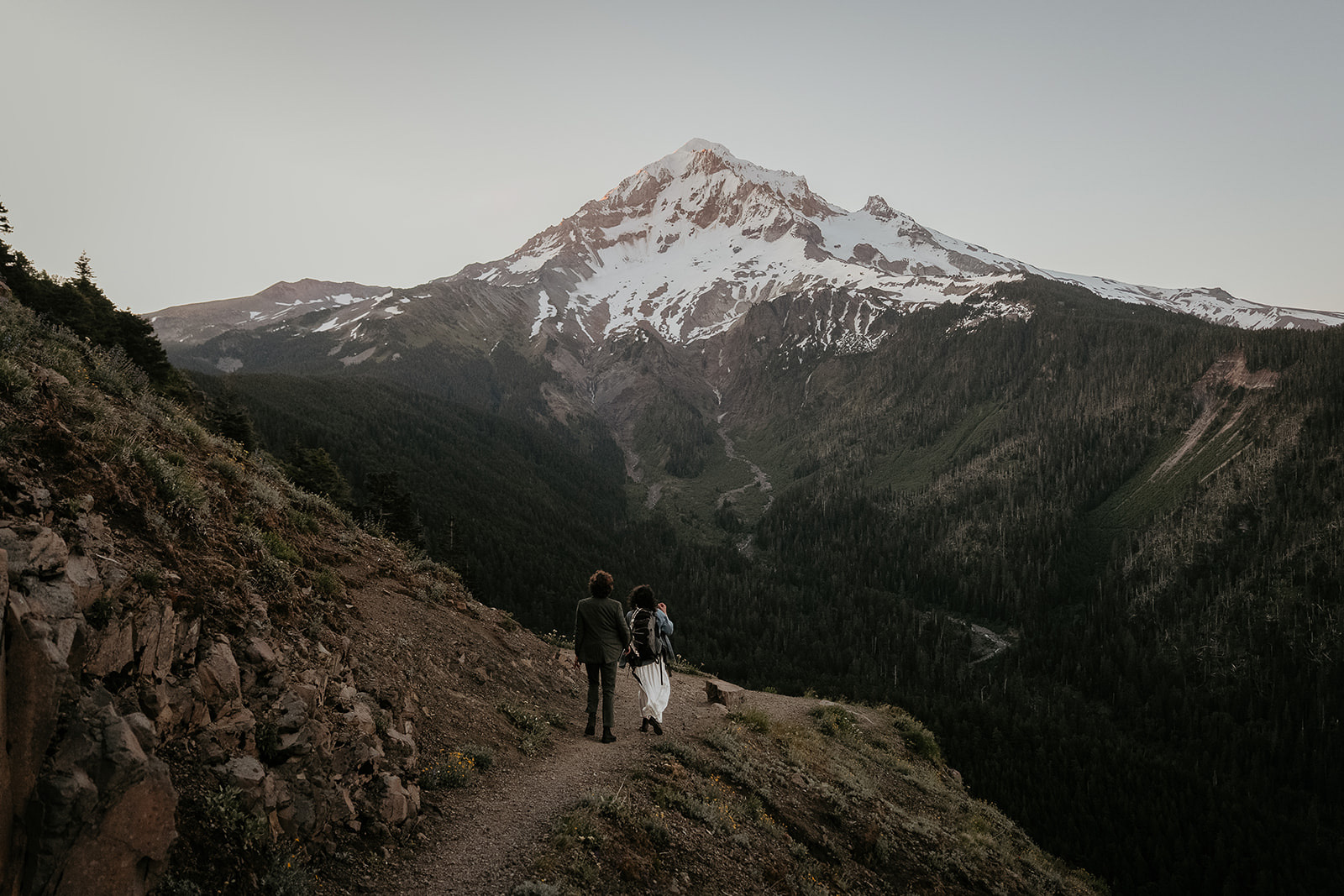 couple hiking with mount Hood in the background during their wedding anniversary photoshoot.