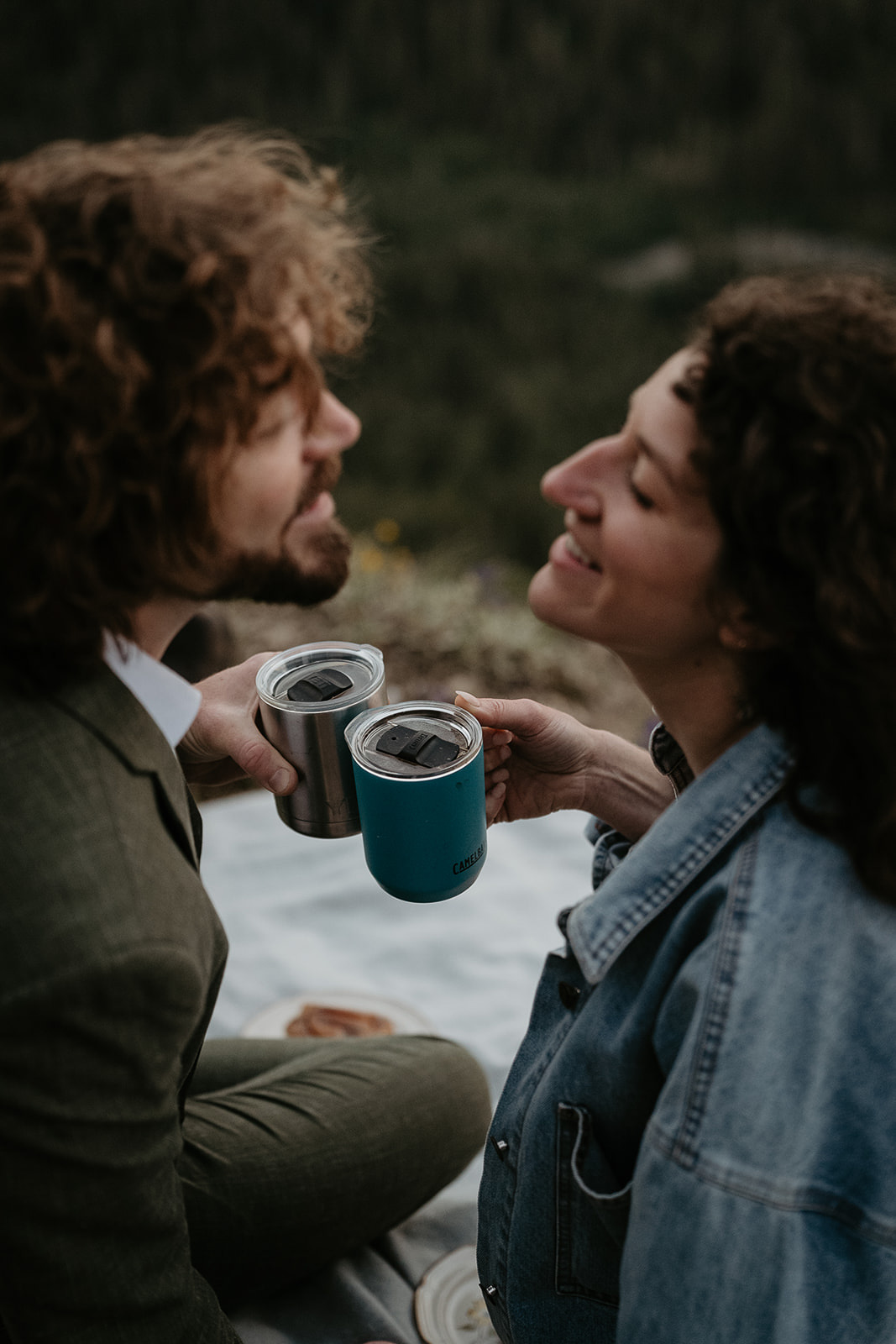 Couple sharing a coffee smiling at each other.