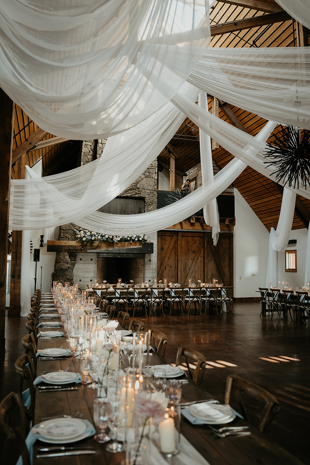 The inside of Brasada Ranch, one of the best wedding venues in Oregon, complete with dinner tables and elaborate drapes.