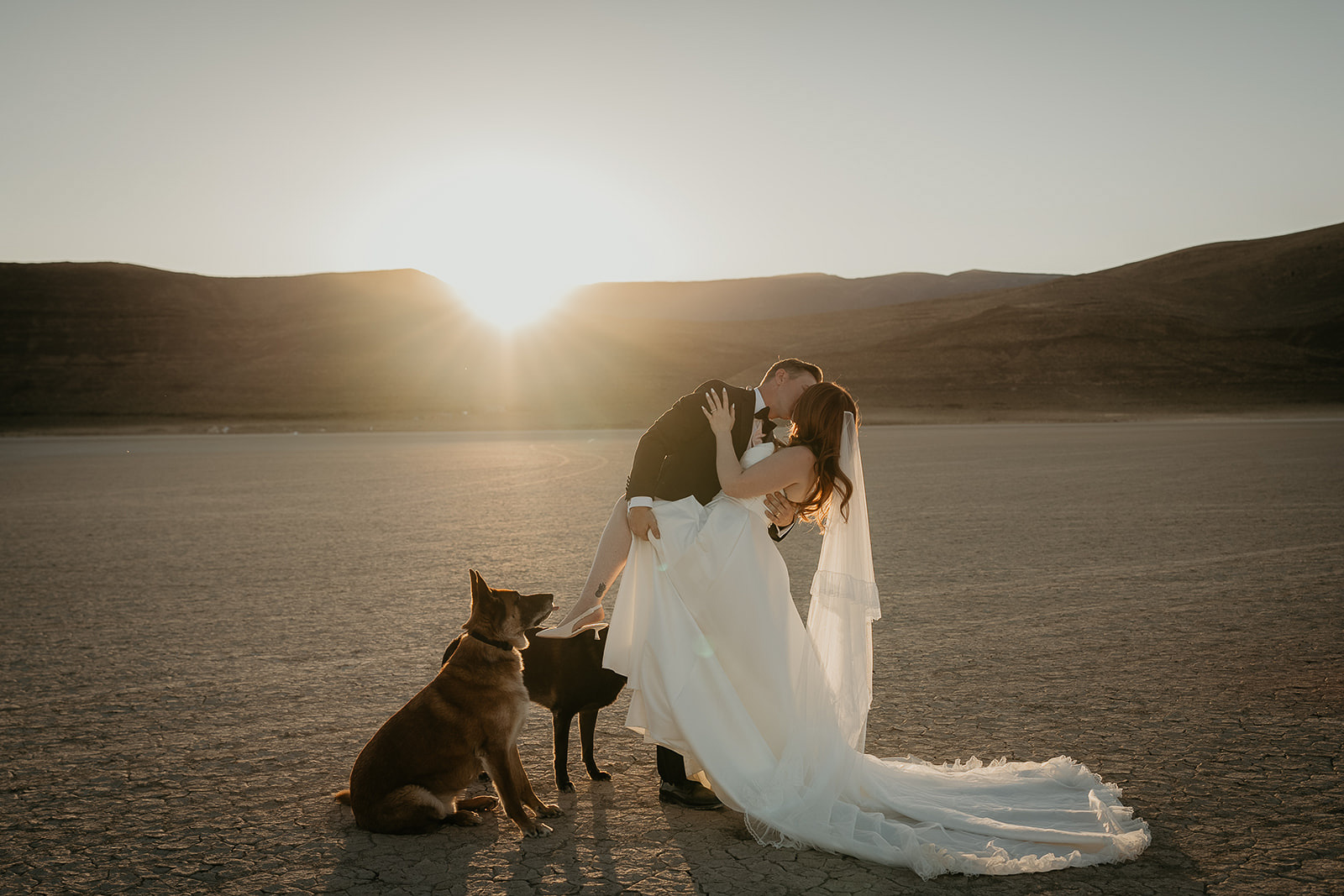 Newlyweds kissing at sunset in the Alvord Desert, one of the best wedding venues in Oregon.