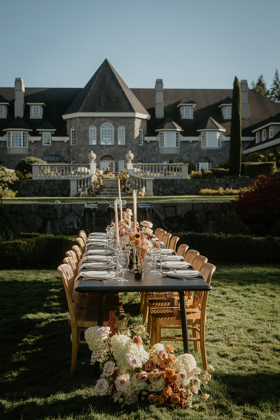 A table set up on a lawn outside Chateau de Michellia, one of the best wedding venues in Oregon.