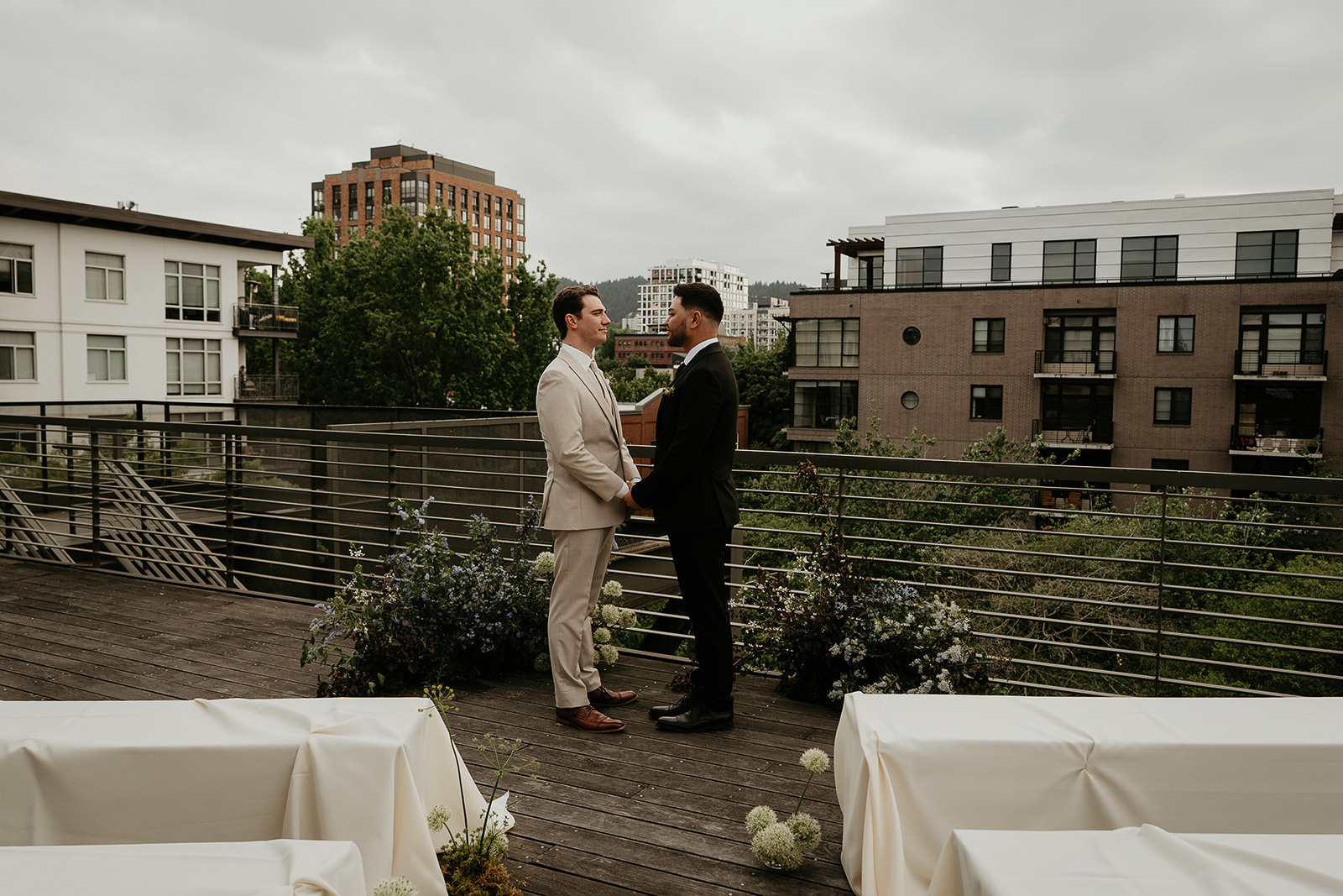 newlyweds holding hands on a rooftop for an Ecotrust wedding styled shoot.