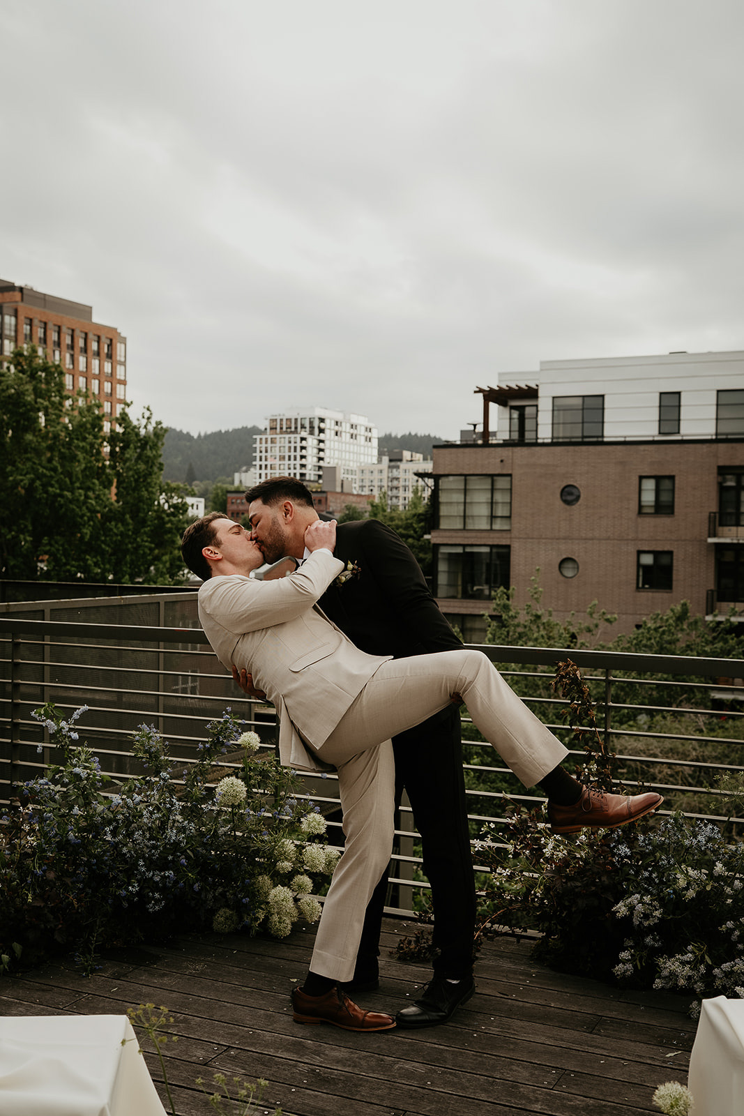 Newlyweds kissing on Ecotrust's rooftop.