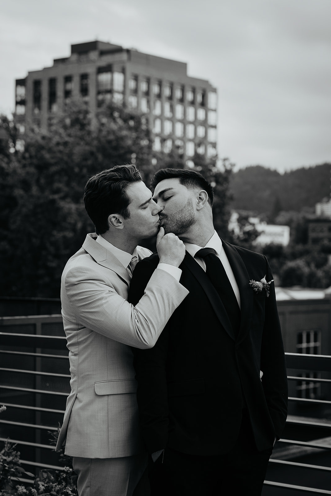 Newlyewds kissing on a rooftop for an Ecotrust wedding styled shoot.