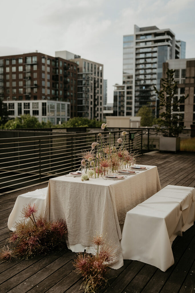 A tablescape with flowers and tablewear.