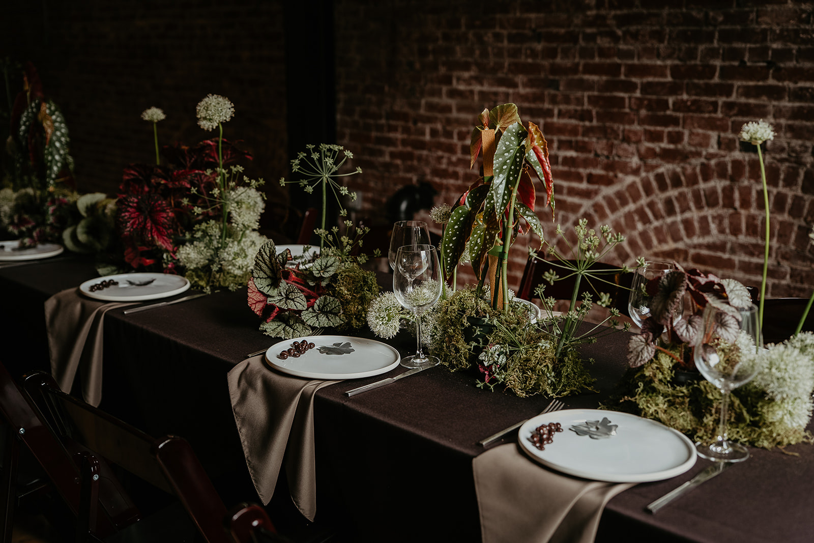 a wedding table filled with flowers and table wear for an Ecotrust wedding styled shoot.