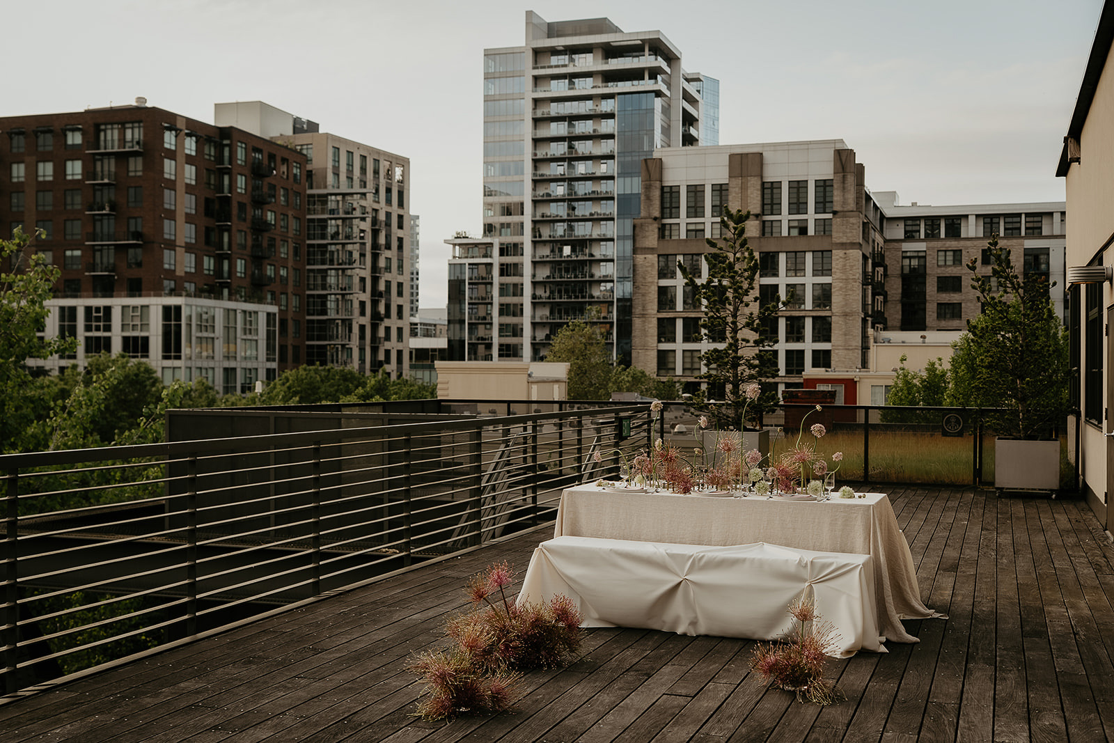 A tablescape on a rooftop with the Portland skyline in the background.