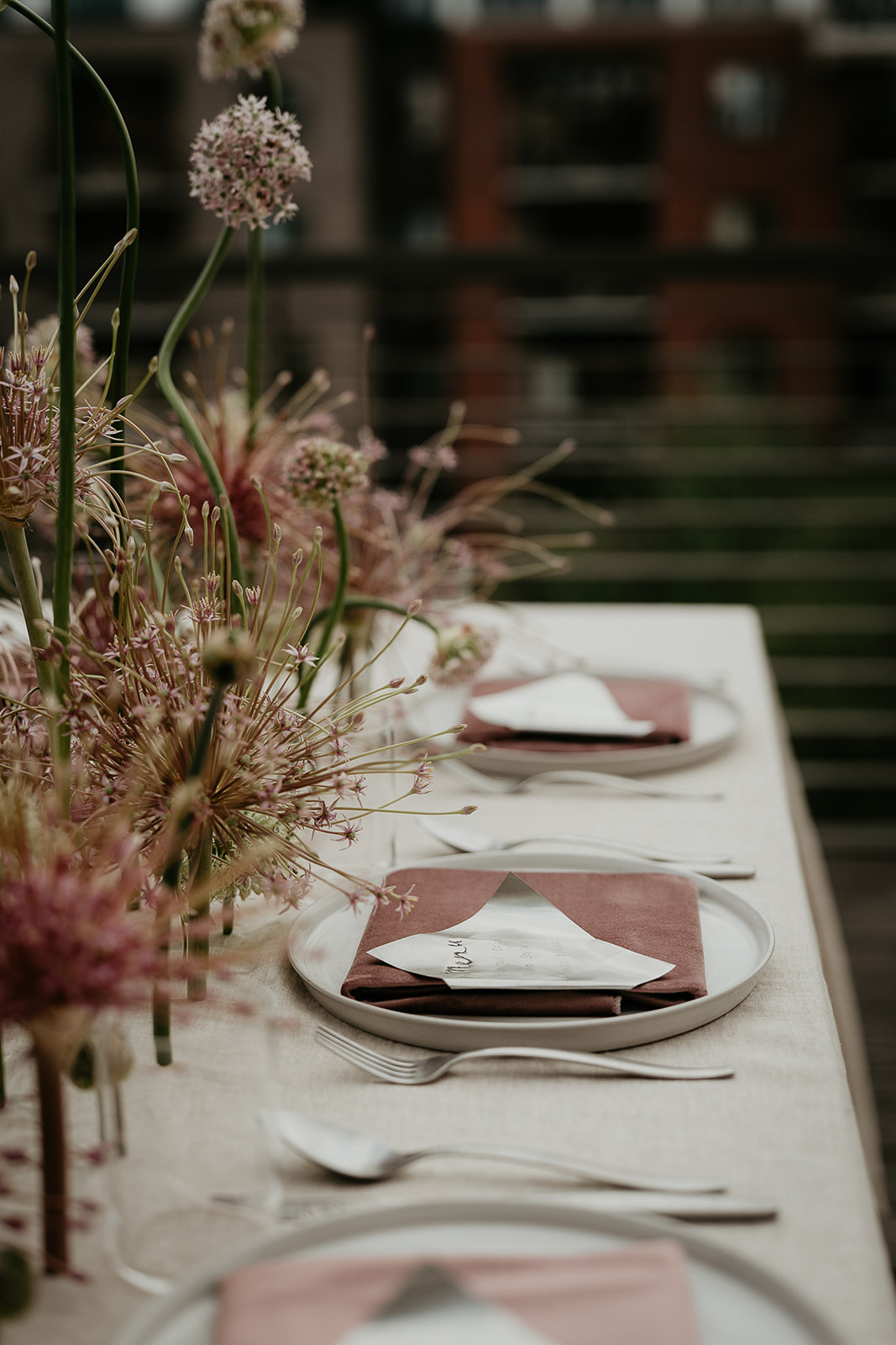 flowers, plates, an utensils on a table for an Ecotrust wedding styled shoot.