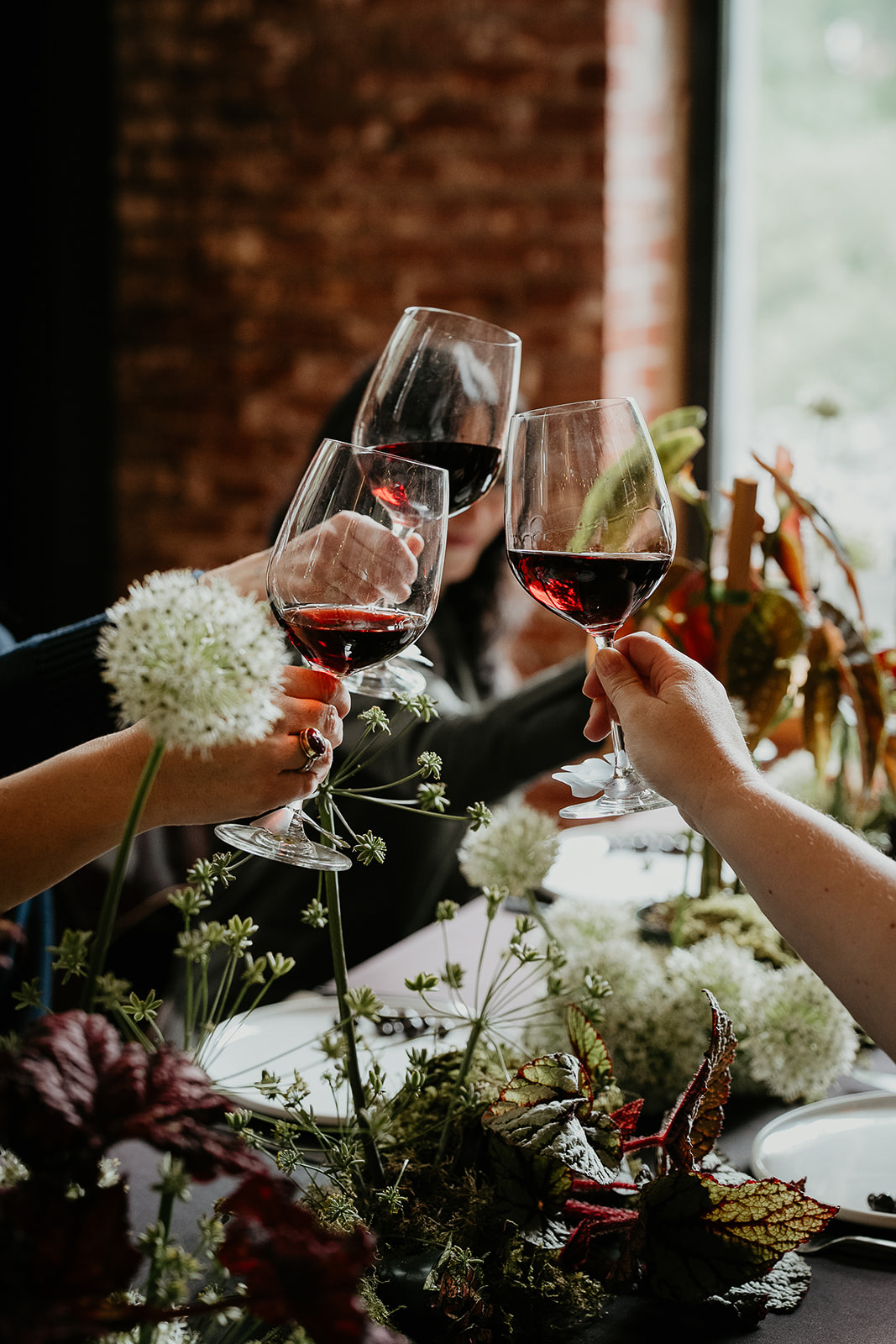 wedding guests cheersing wine glasses.