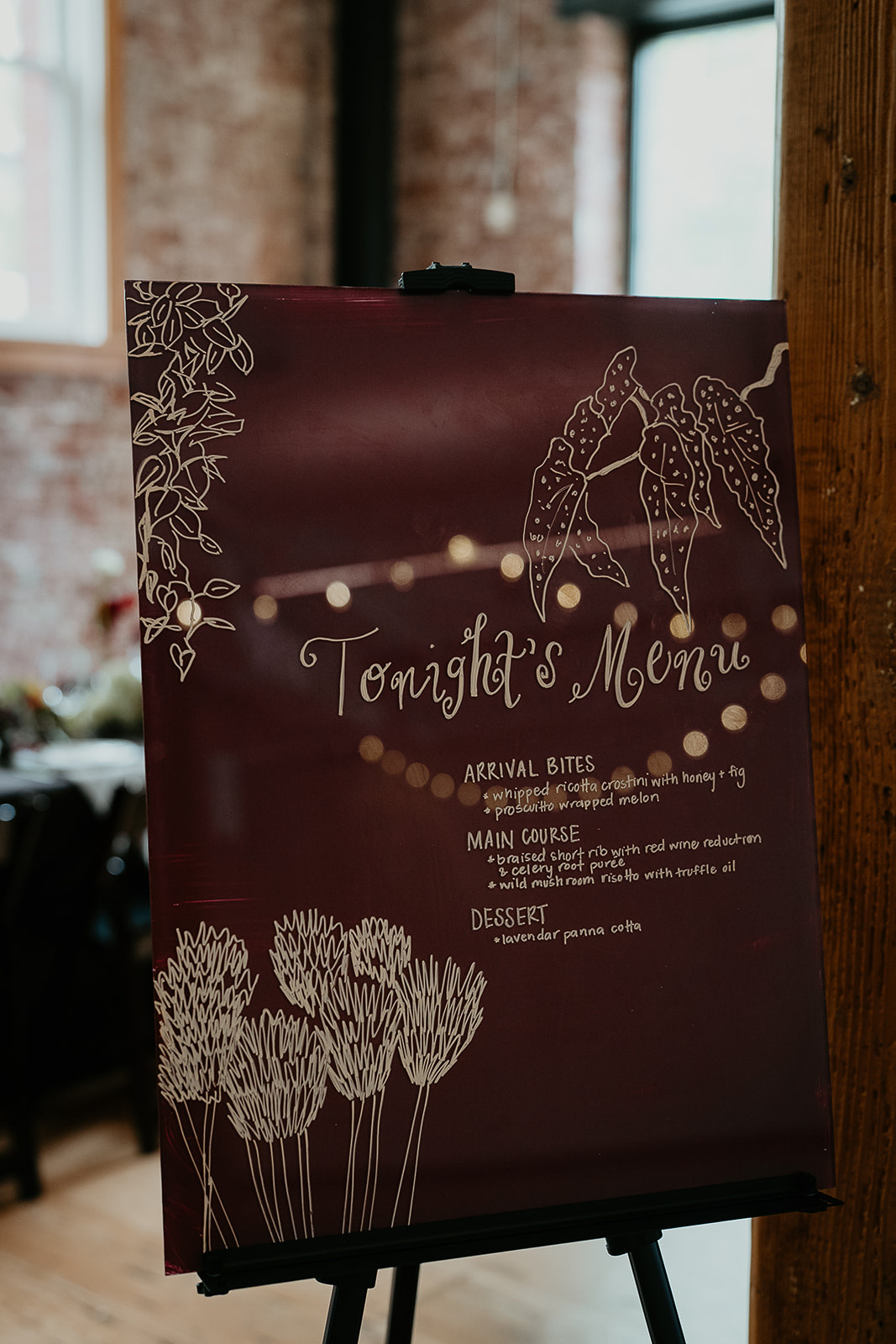 A sign with the rehearsal dinner menu.