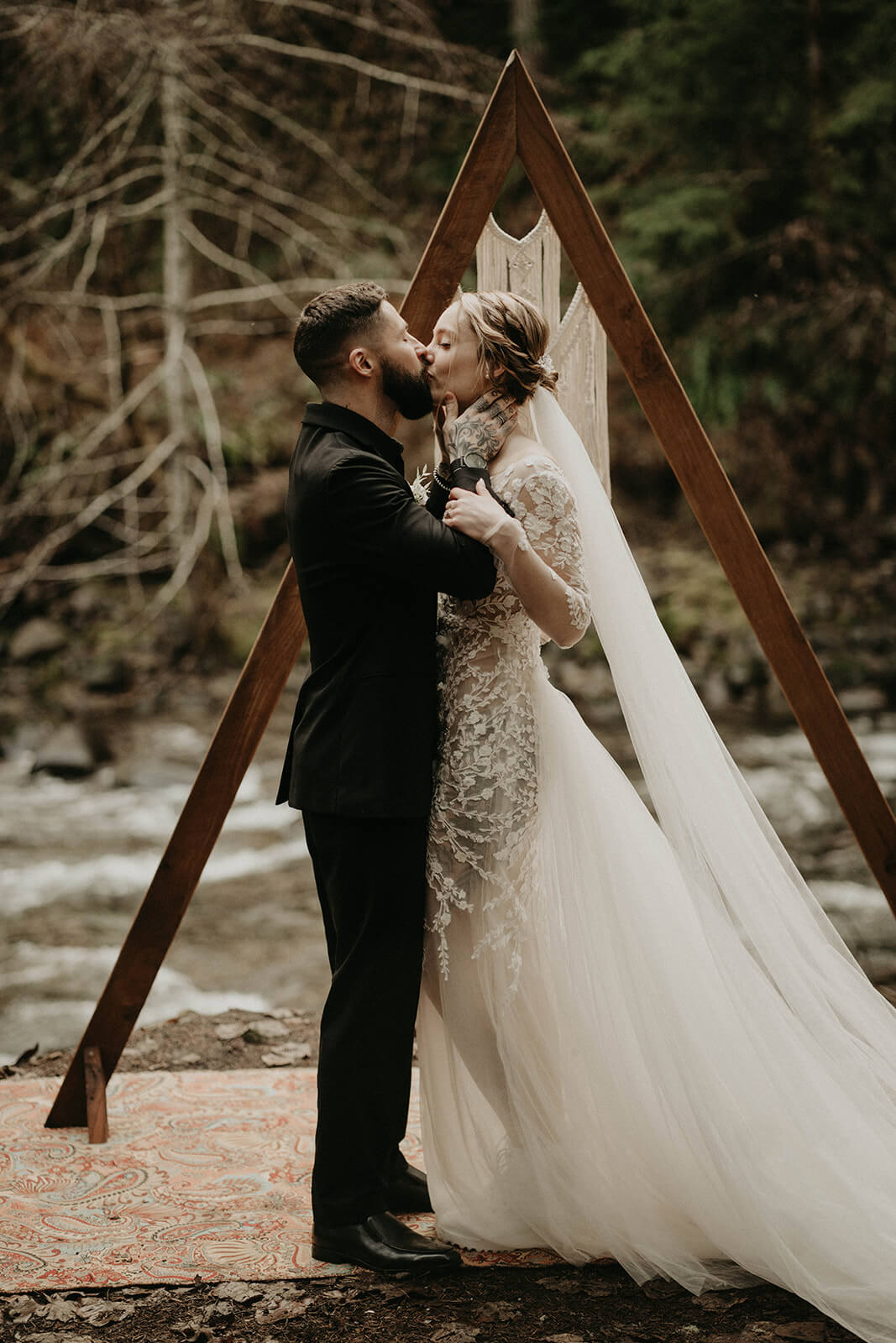 Bride and groom kiss during Mount Rainier elopement ceremony