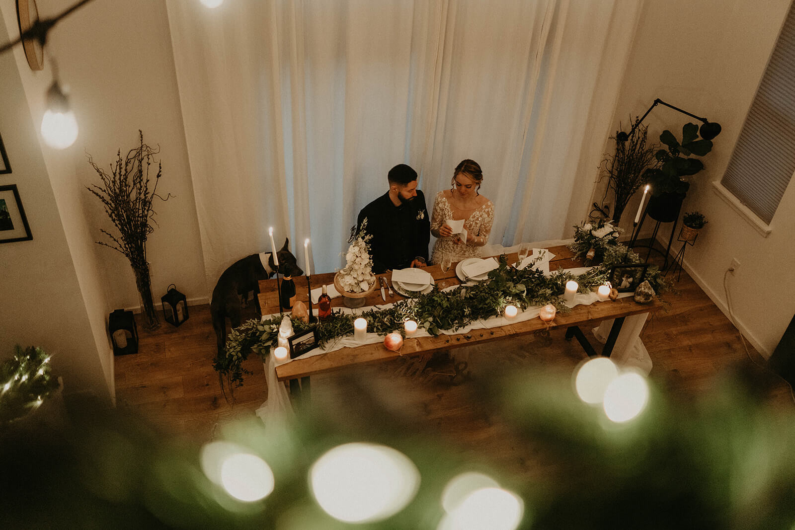 Bride and groom reading letters at the dining table in cozy cabin