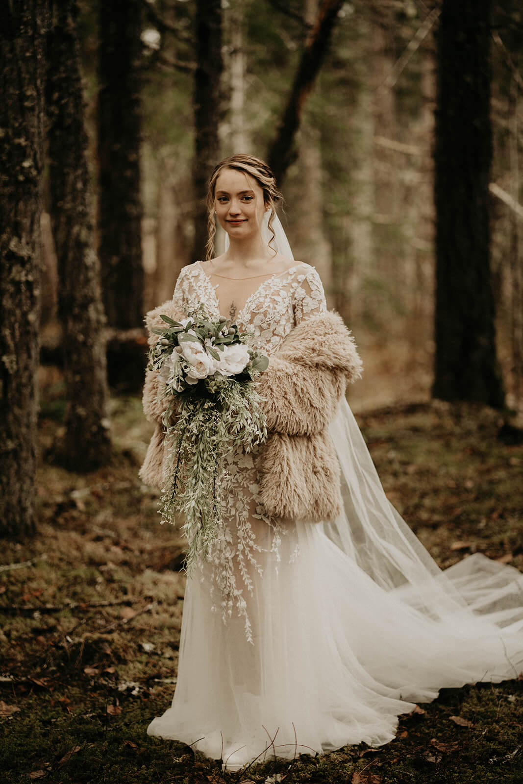 Bride holding white bouquet in the woods before mount rainier elopement ceremony