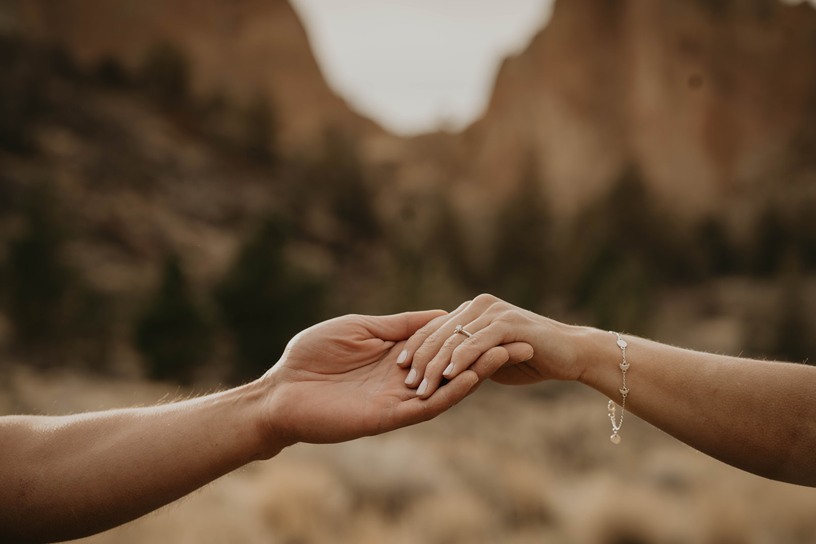 Couple holding hands at Smith Rock State Park