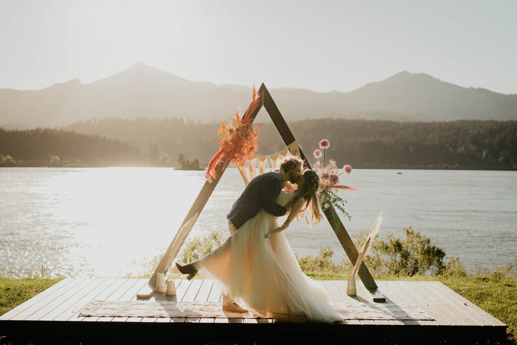 Bride and groom kiss during elopement styled shoot wedding ceremony