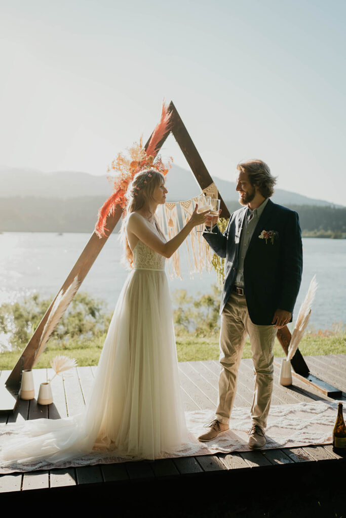 Bride and groom pop champagne after styled shoot wedding ceremony