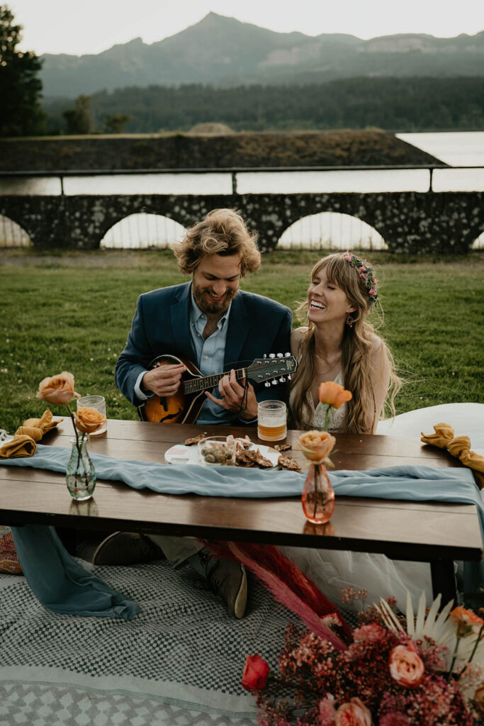 Groom playing guitar for bride during elopement styled shoot on Thunder Island