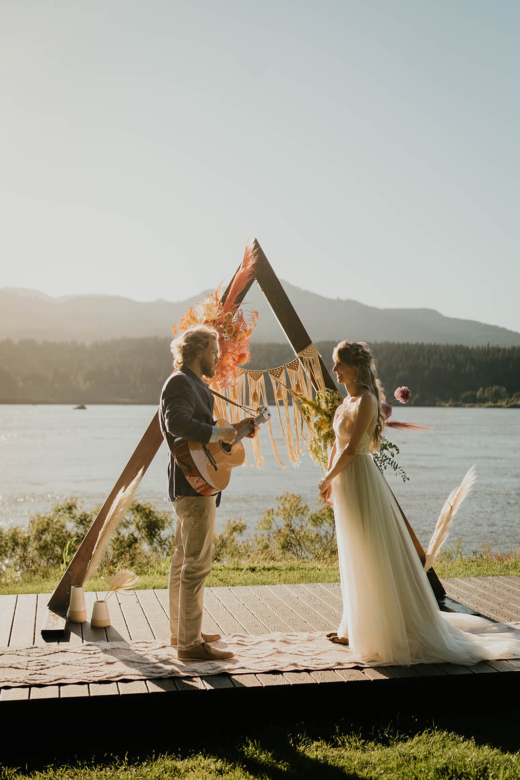 Groom playing guitar for bride during Thunder Island elopement styled shoot