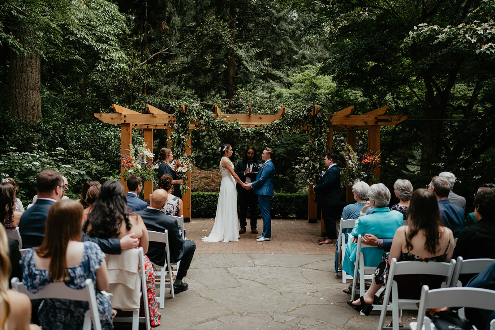 Two brides at Leach Botanical Garden wedding altar