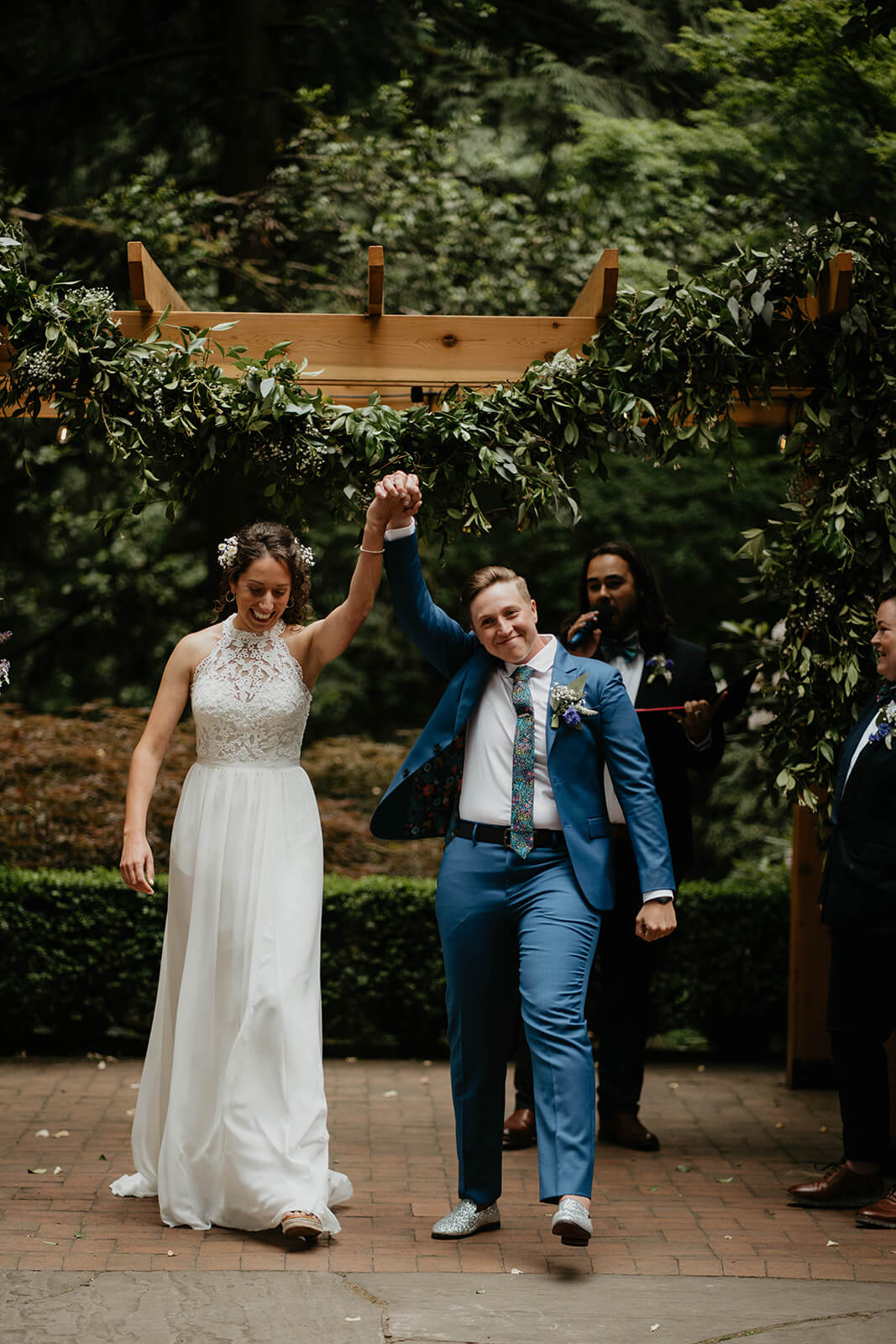 Two brides exiting Leach Botanical Garden wedding altar