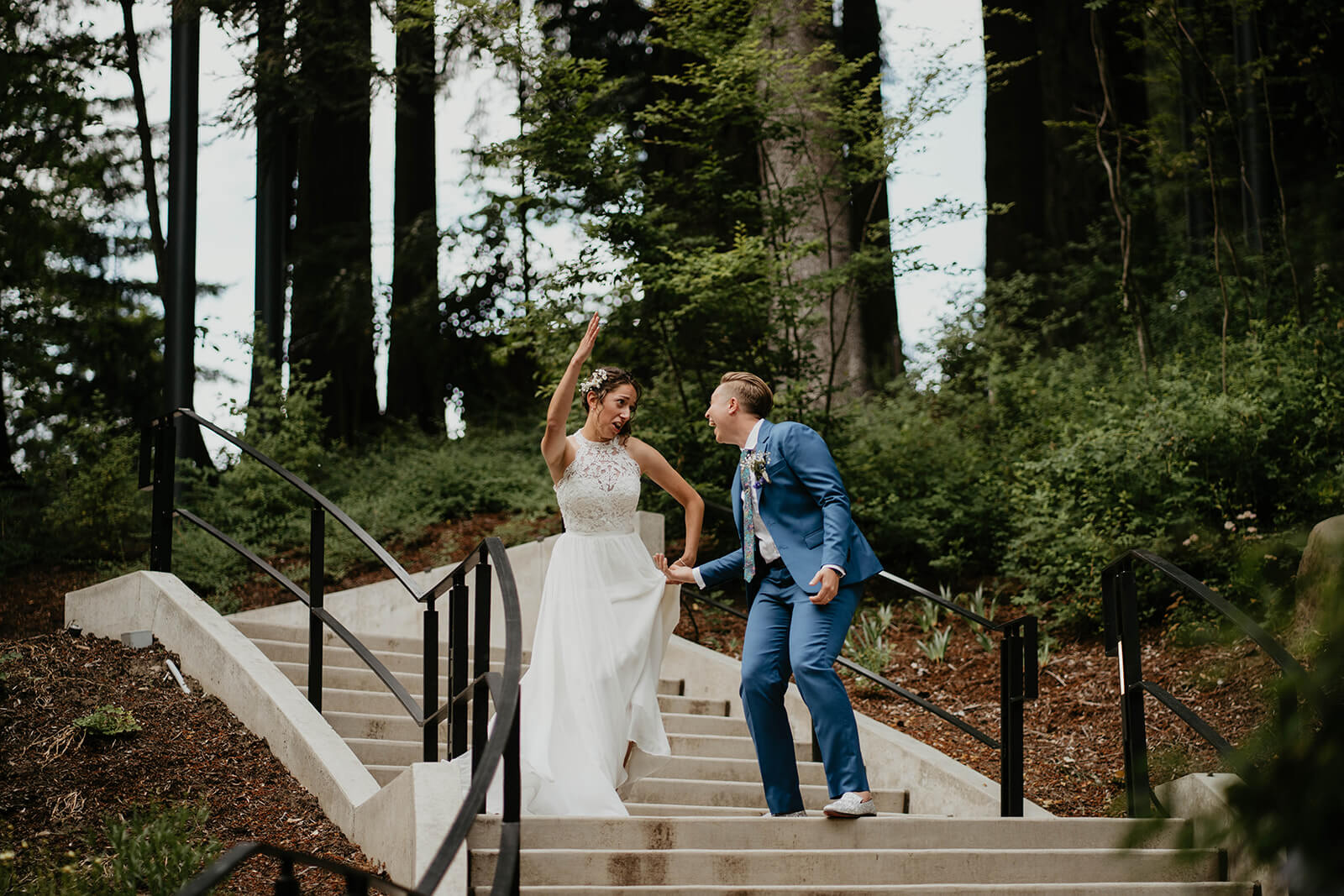 Two brides dance as they enter Leach Botanical Garden wedding reception