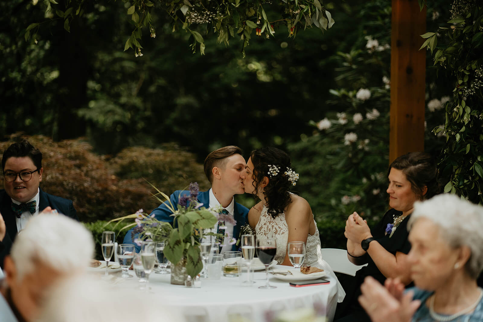 Two brides kiss at Leach Botanical Garden wedding reception
