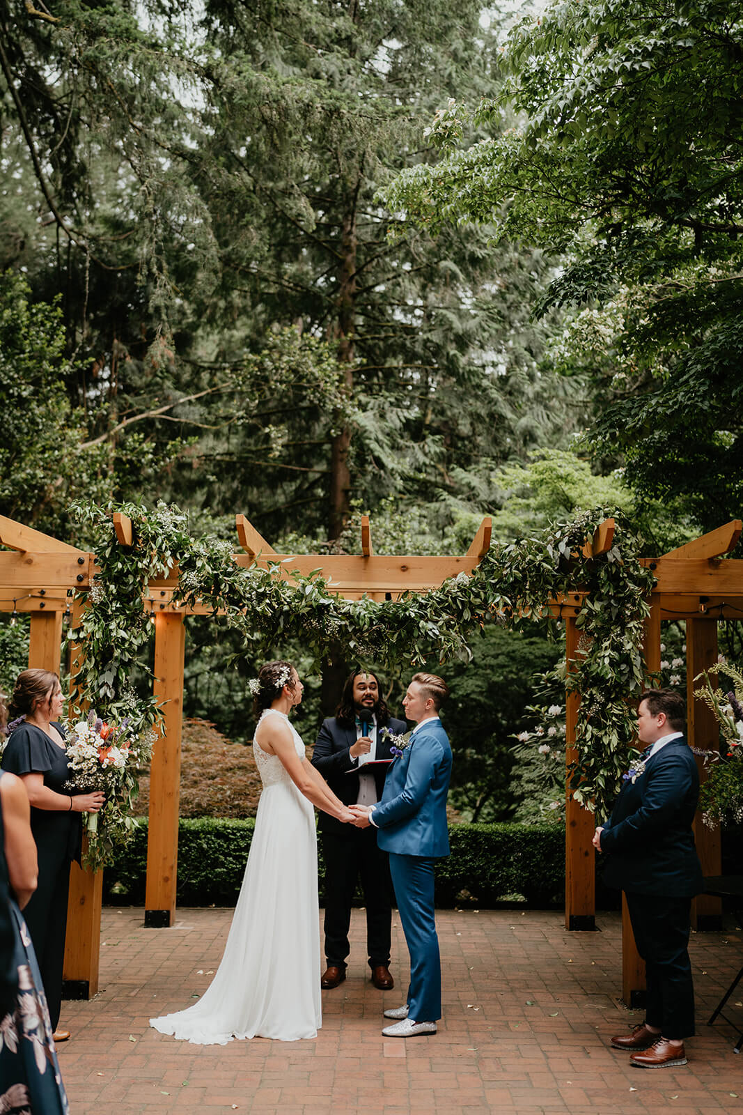 Two brides at Leach Botanical Garden wedding altar