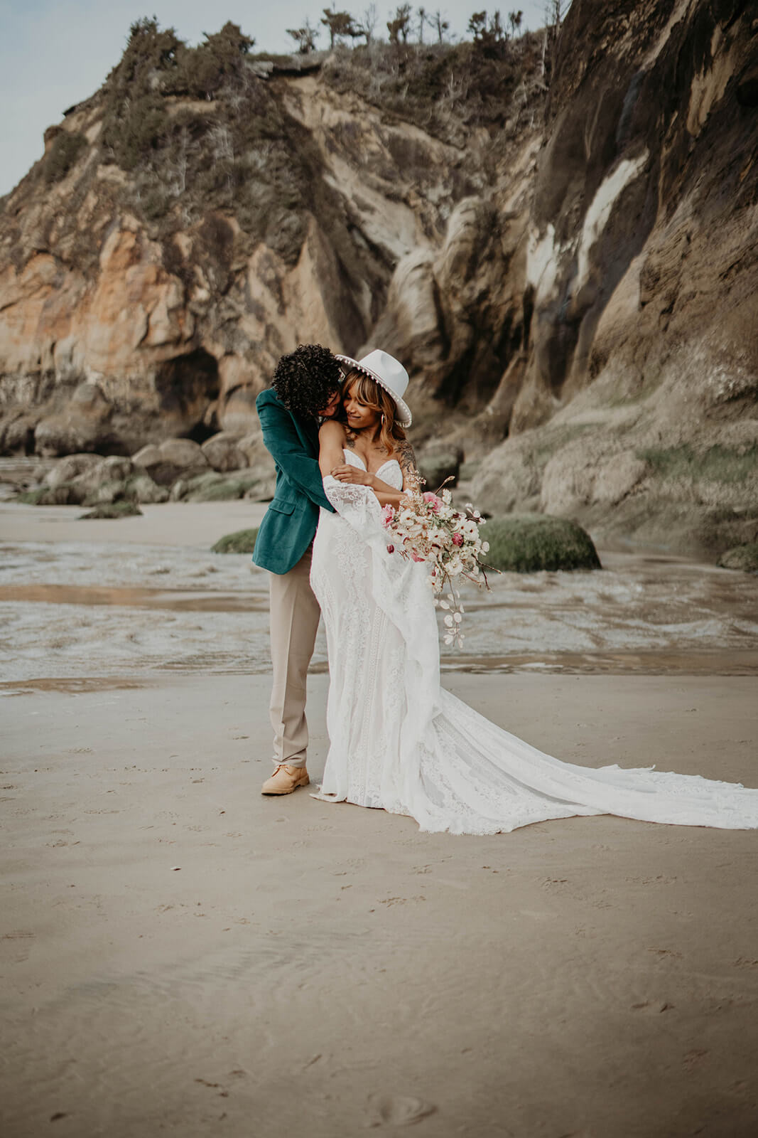Bride and groom hug during elopement on the Oregon Coast