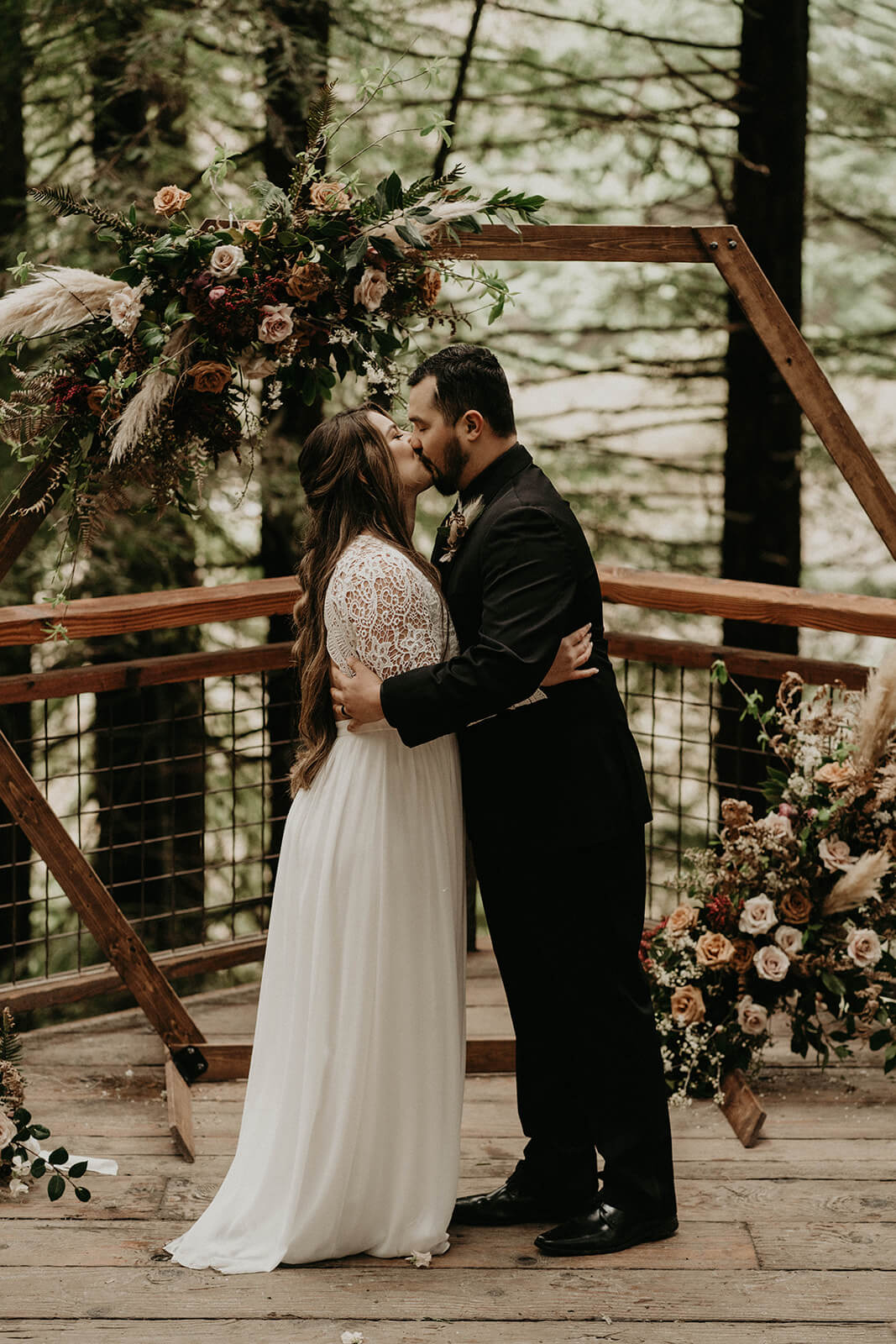 Bride and groom kiss at Hoyt Arboretum wedding ceremony
