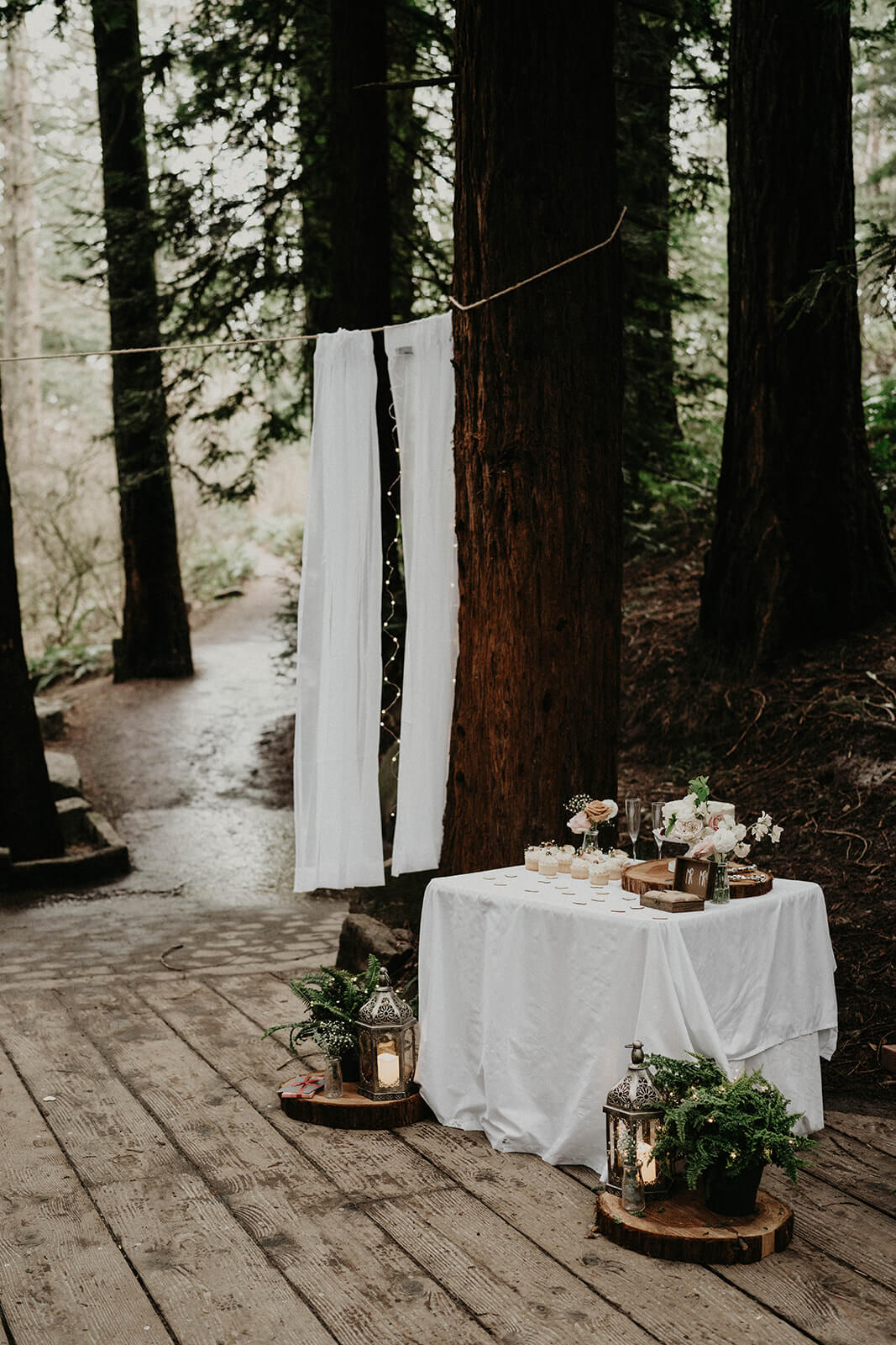 White reception table for forest wedding