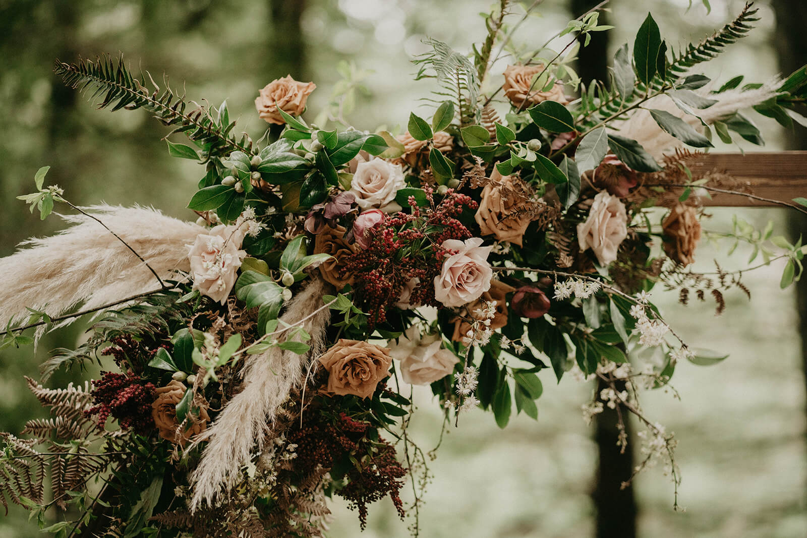 pink and burgundy floral display for forest wedding